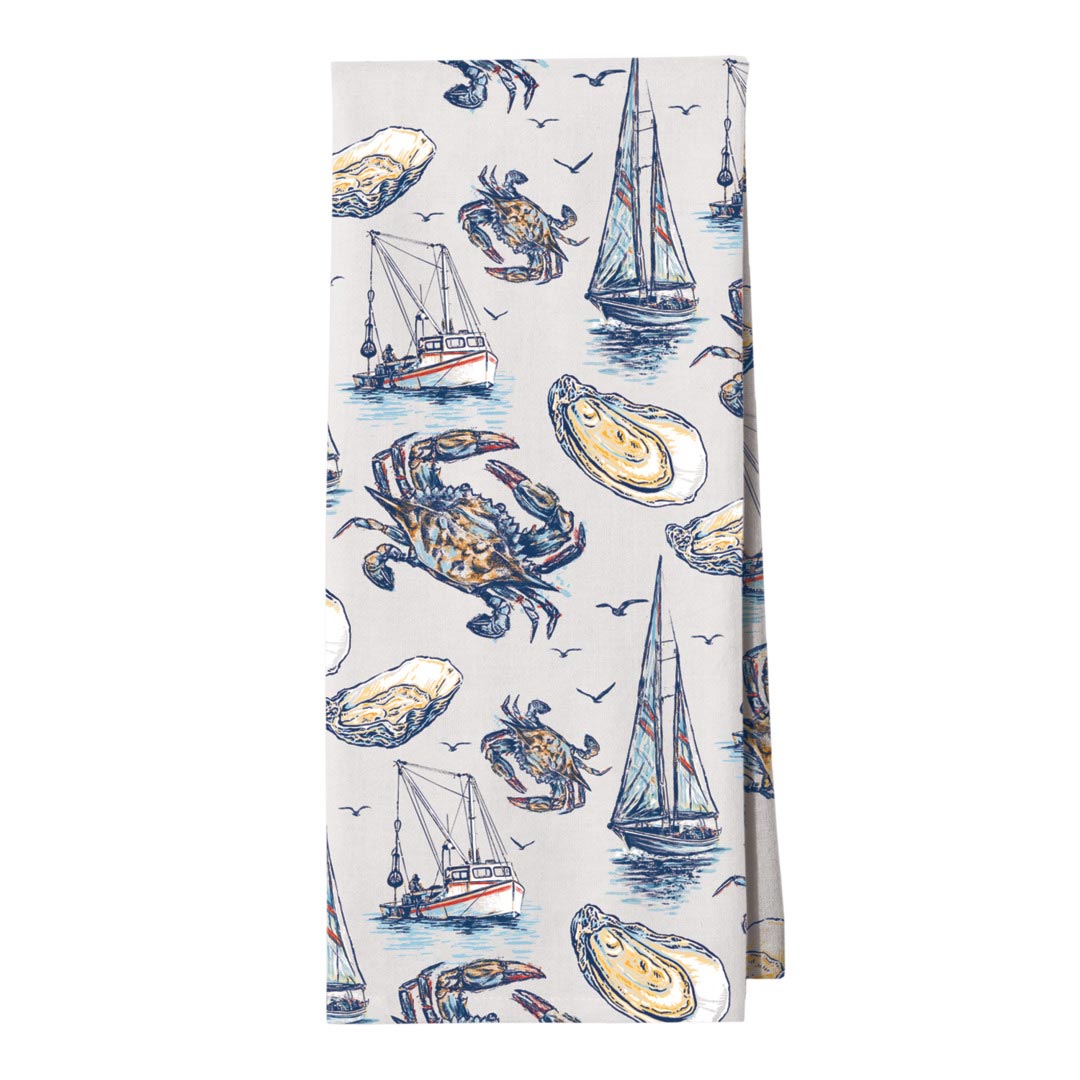 Towel with nautical design featuring crabs, oysters, and boats on a white background